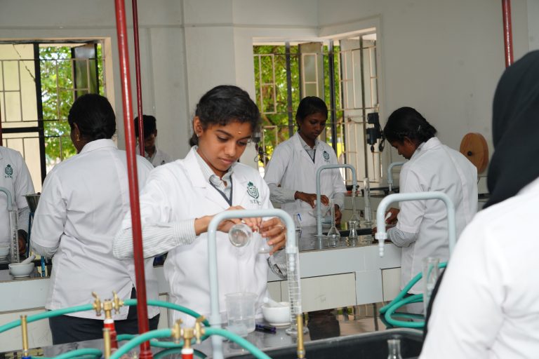 Pharmacy students performing practical experiments in ST Pharmacy College laboratory