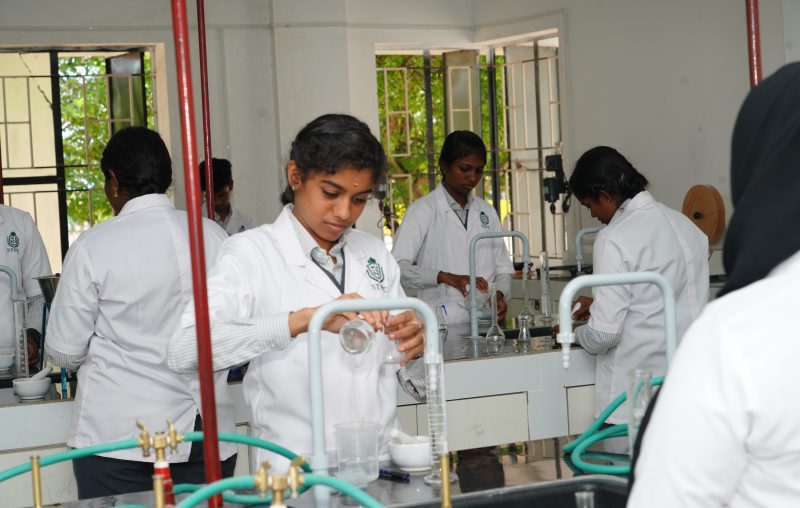 Pharmacy students performing practical experiments in ST Pharmacy College laboratory